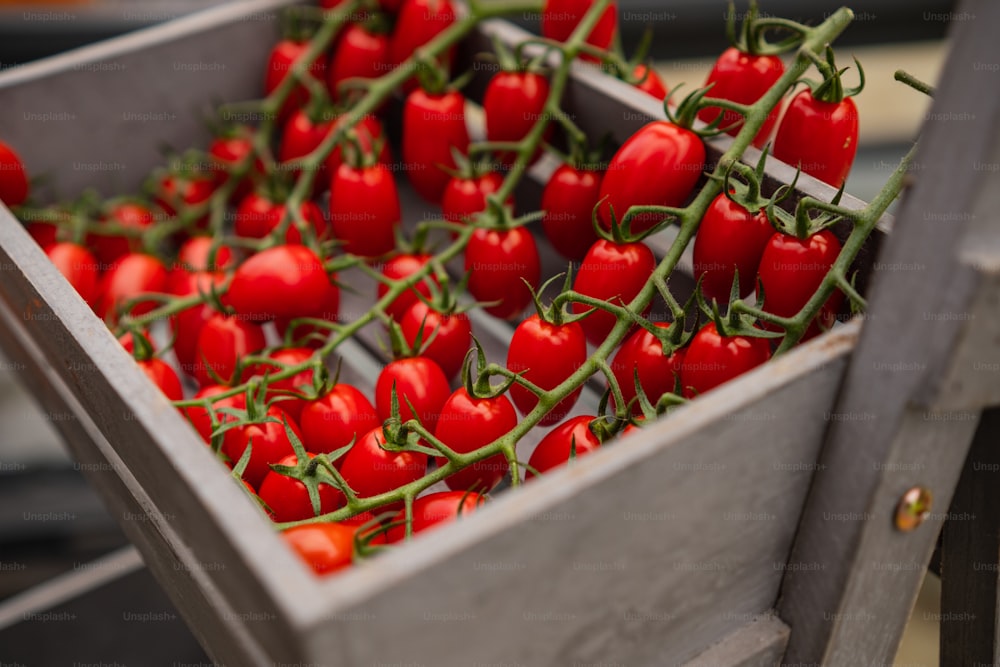 a crate filled with lots of red peppers