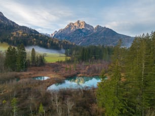 a mountain range with a river in the foreground