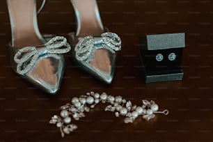 a pair of high heeled shoes sitting next to a jewelry box