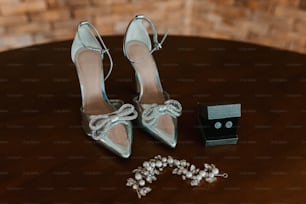 a pair of high heeled shoes sitting on top of a wooden table