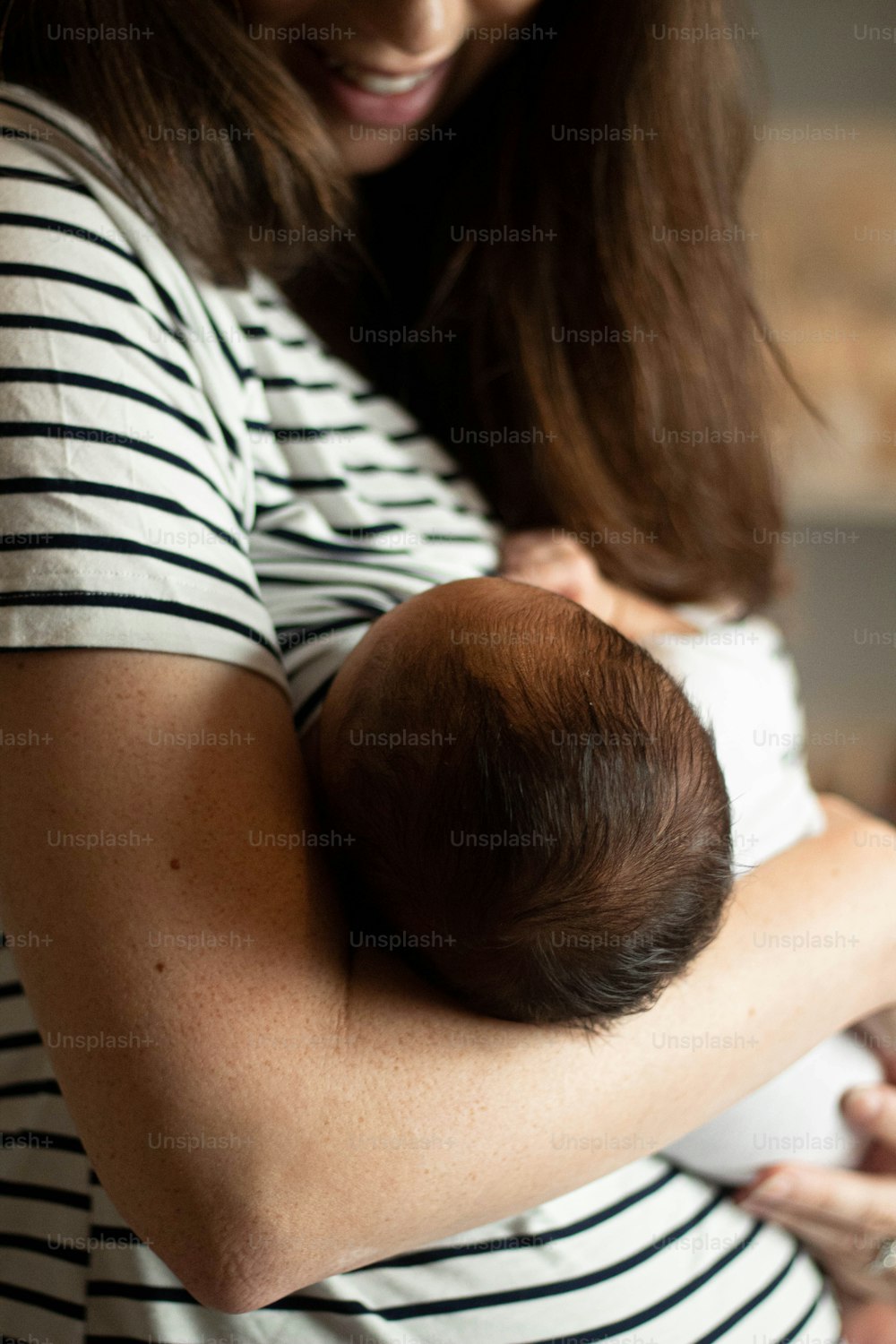 a woman holding a baby in her arms