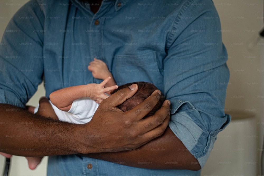 a man holding a baby in his arms