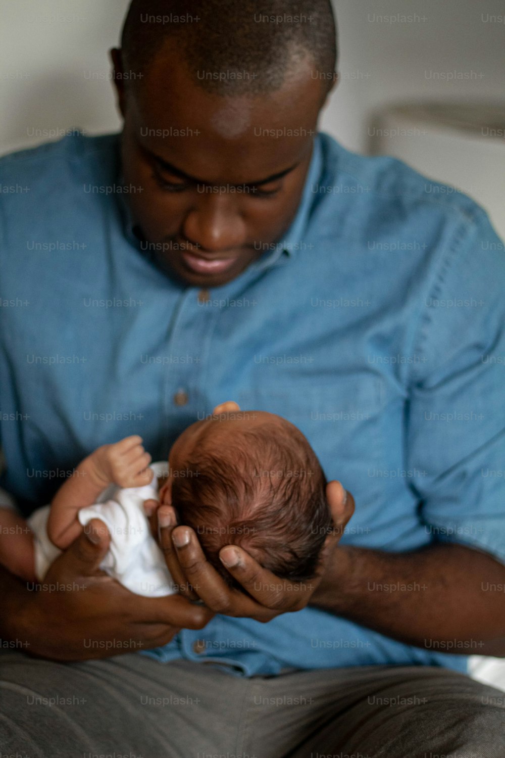 a man holding a baby in his hands