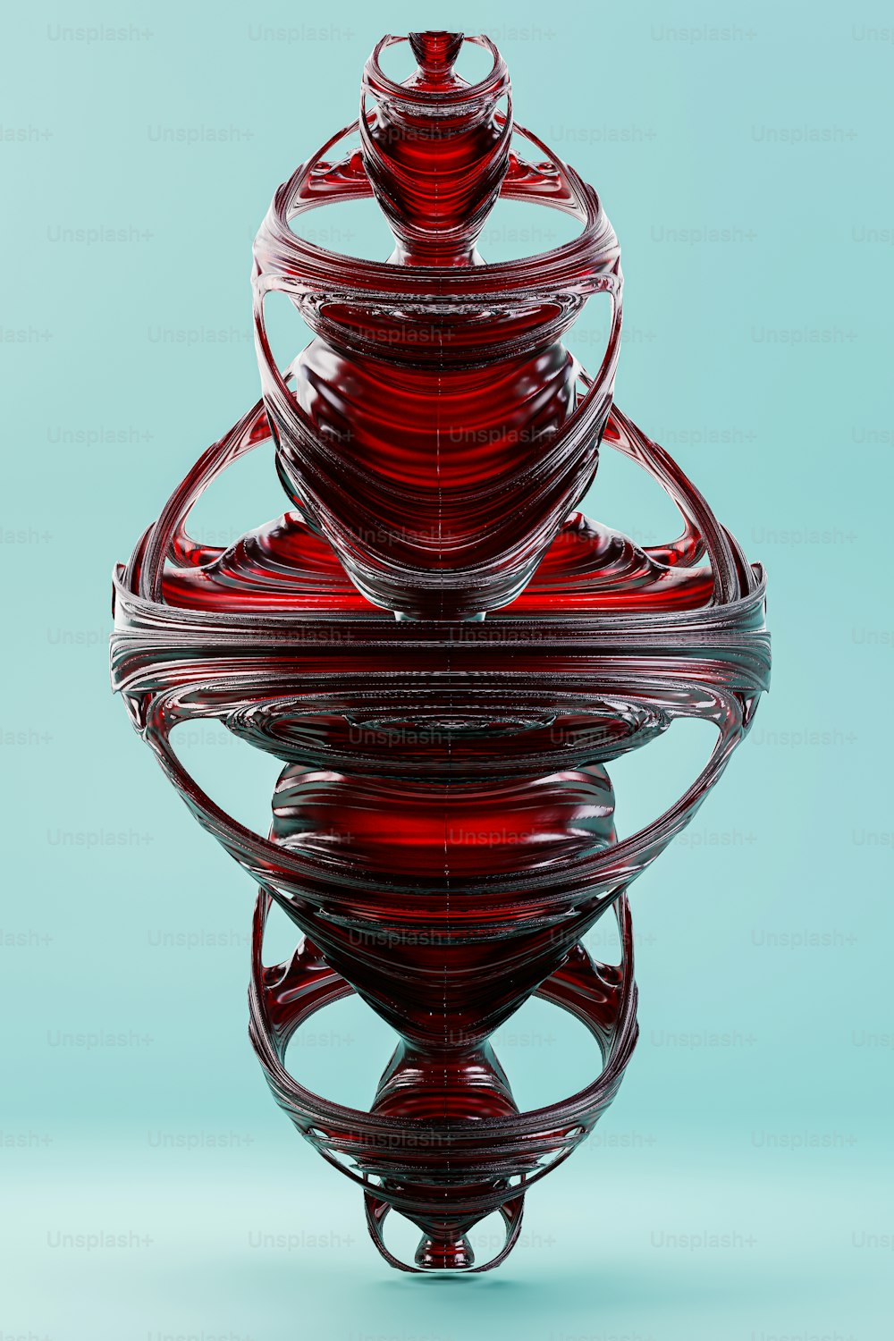 a red glass object sitting on top of a blue surface