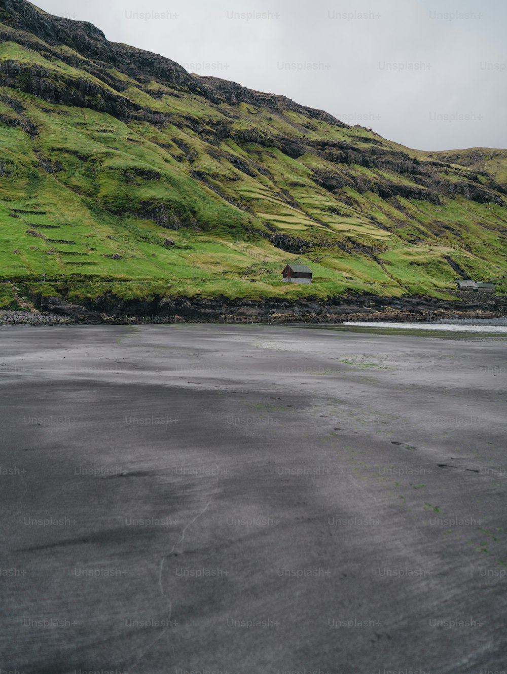 a grassy hill with a house on it