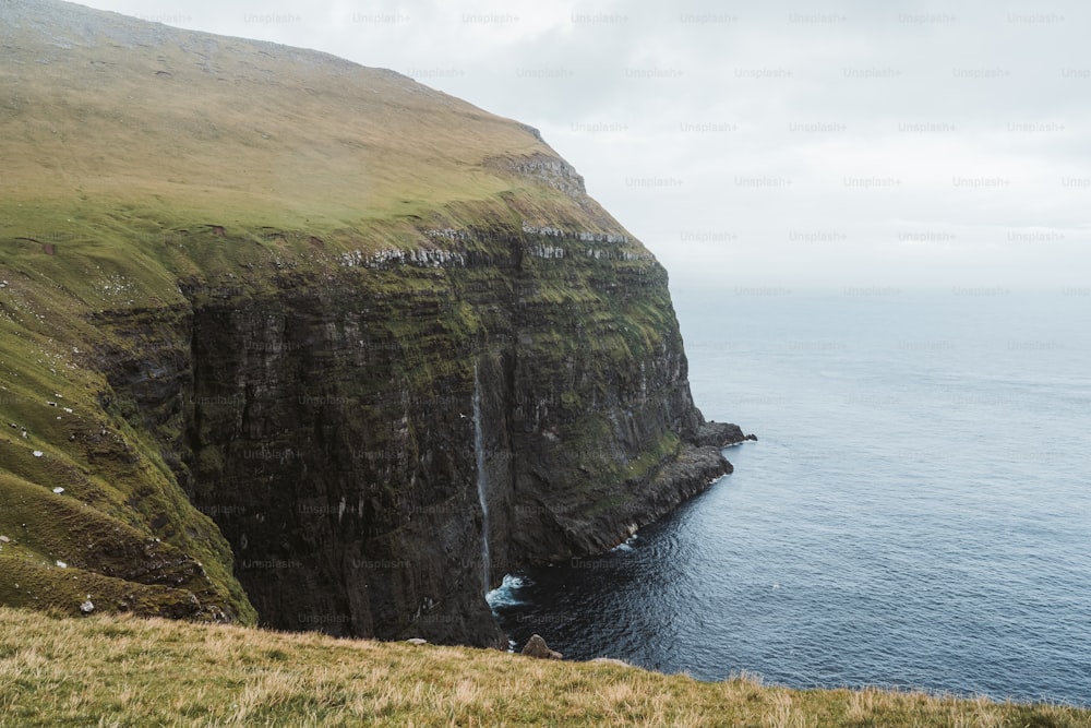 a cliff with a waterfall in the middle of it