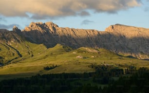 a mountain range with a house in the foreground