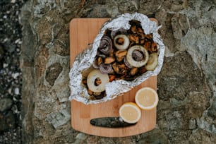 a cutting board topped with sliced oranges and mushrooms