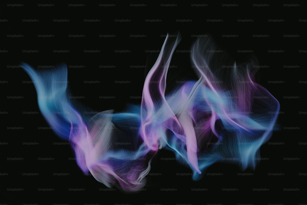 a blurry image of blue and purple smoke on a black background