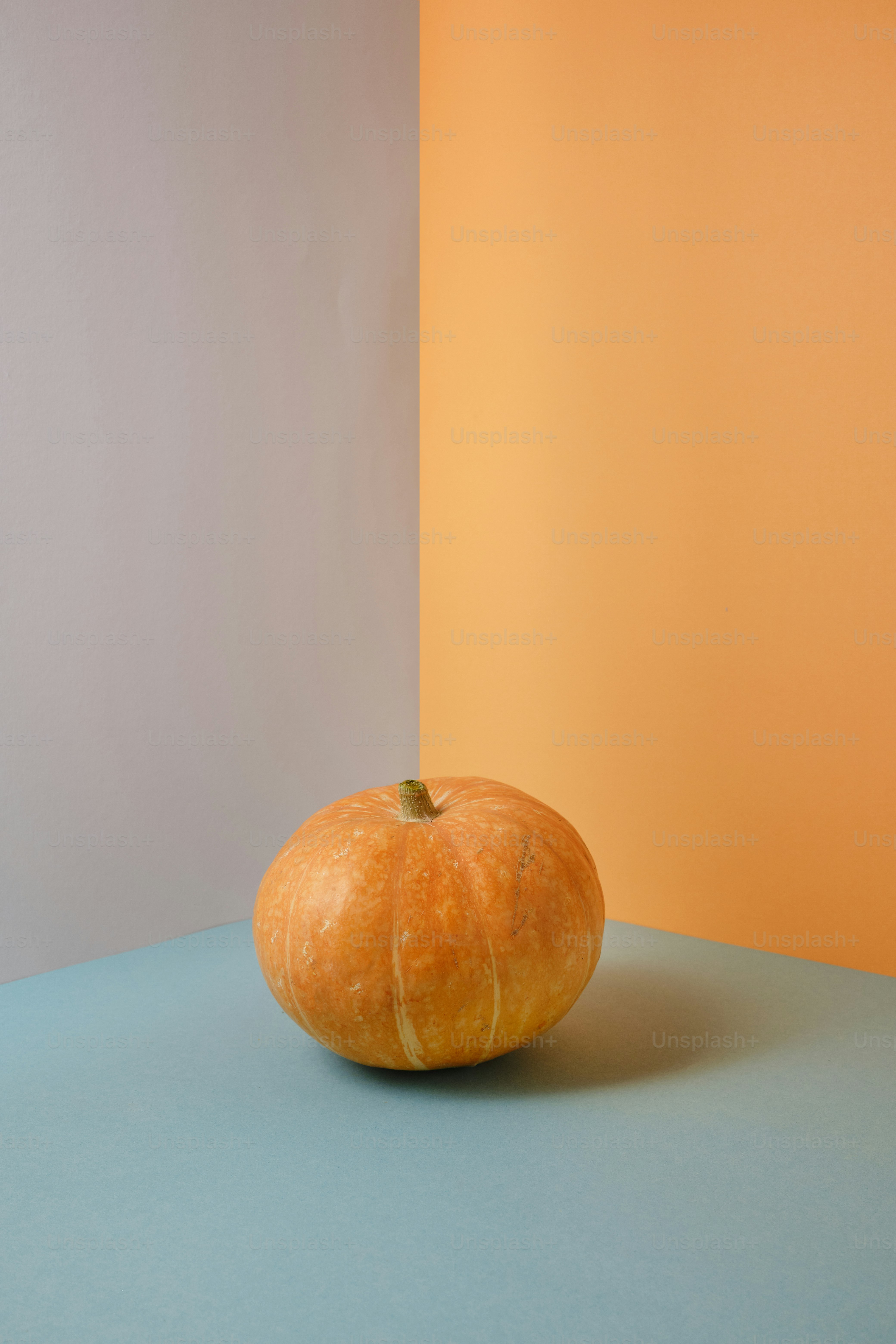 an orange sitting on top of a blue table