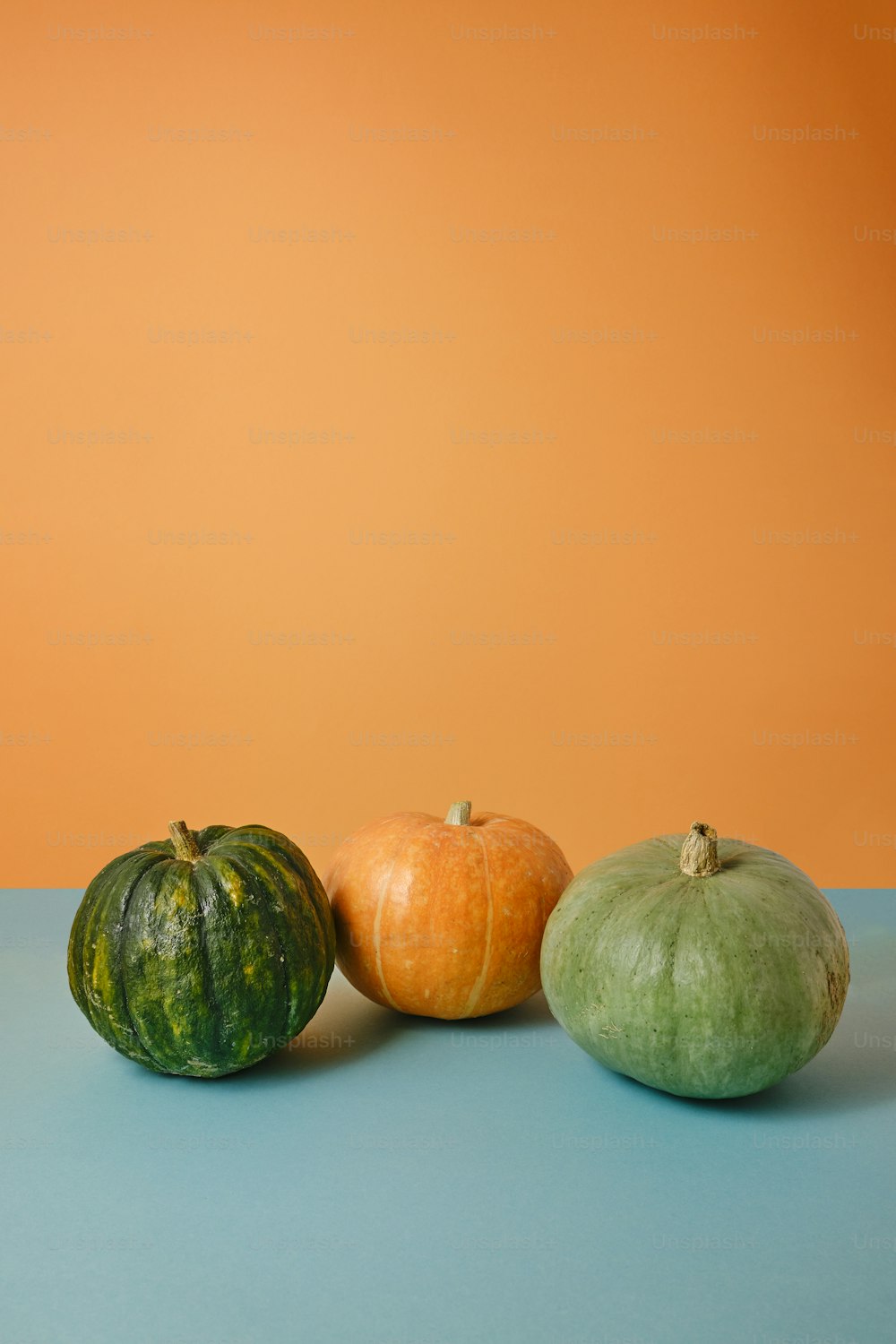 three different types of vegetables on a blue surface