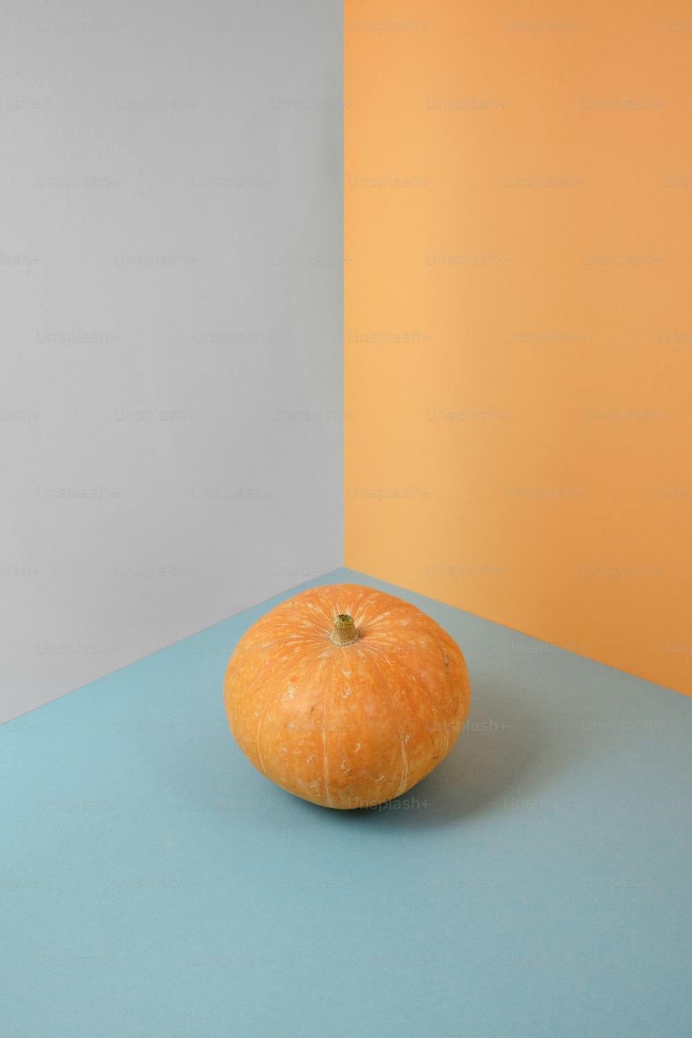 a large orange sitting on top of a blue table
