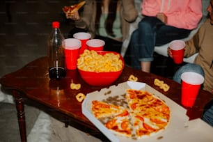 a table topped with a pizza covered in cheese