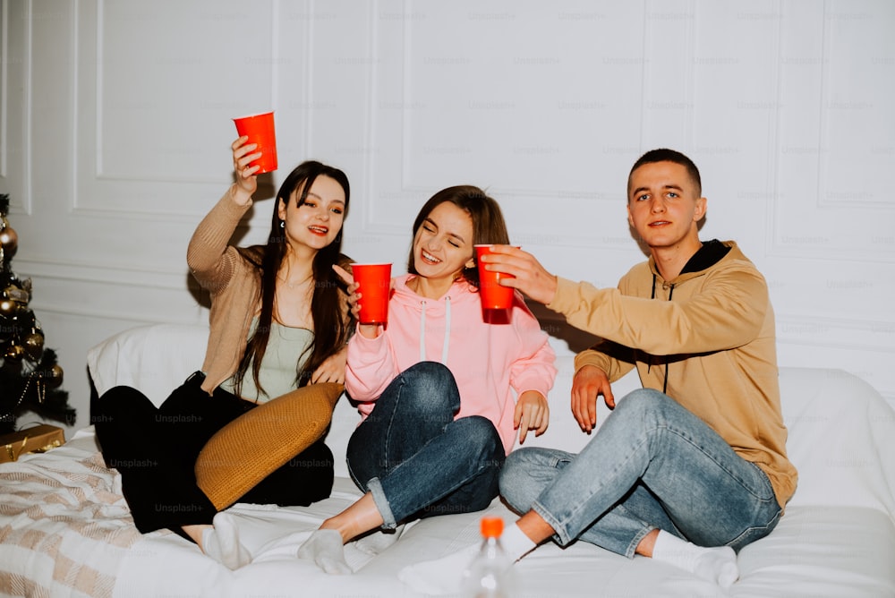 a group of people sitting on top of a bed