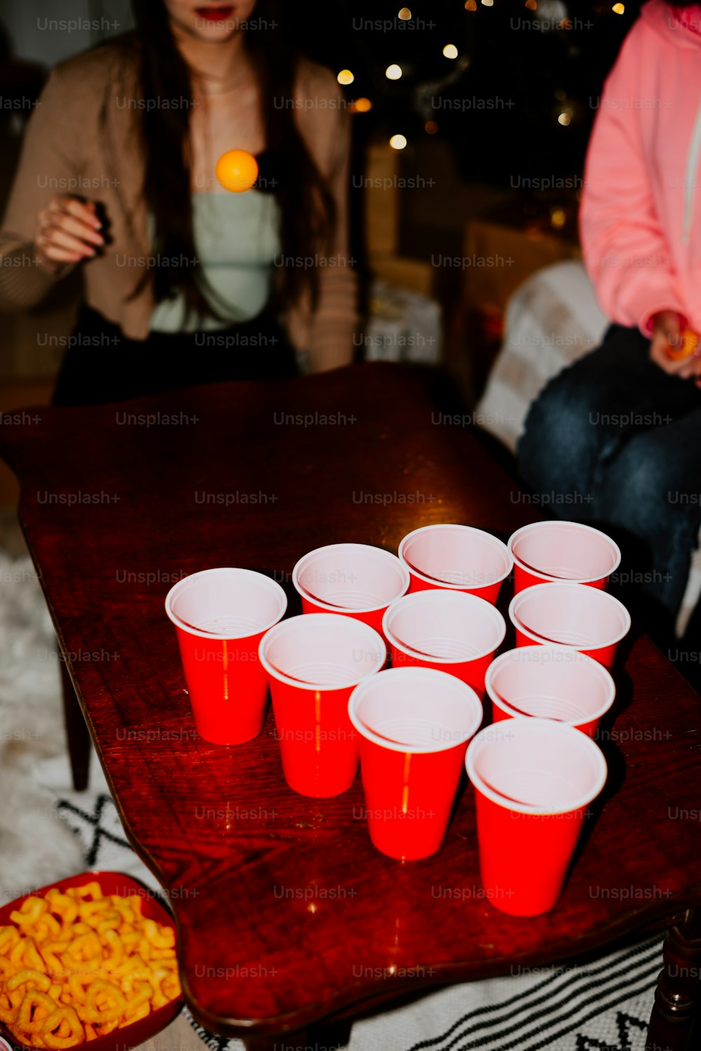 a group of people sitting around a table with cups on it