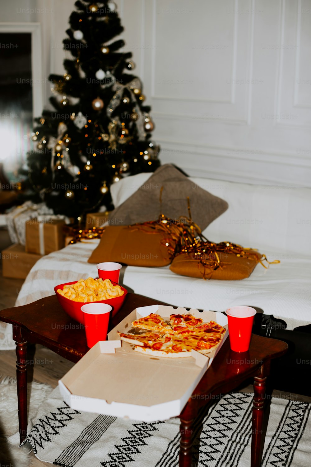 a living room with a christmas tree in the background