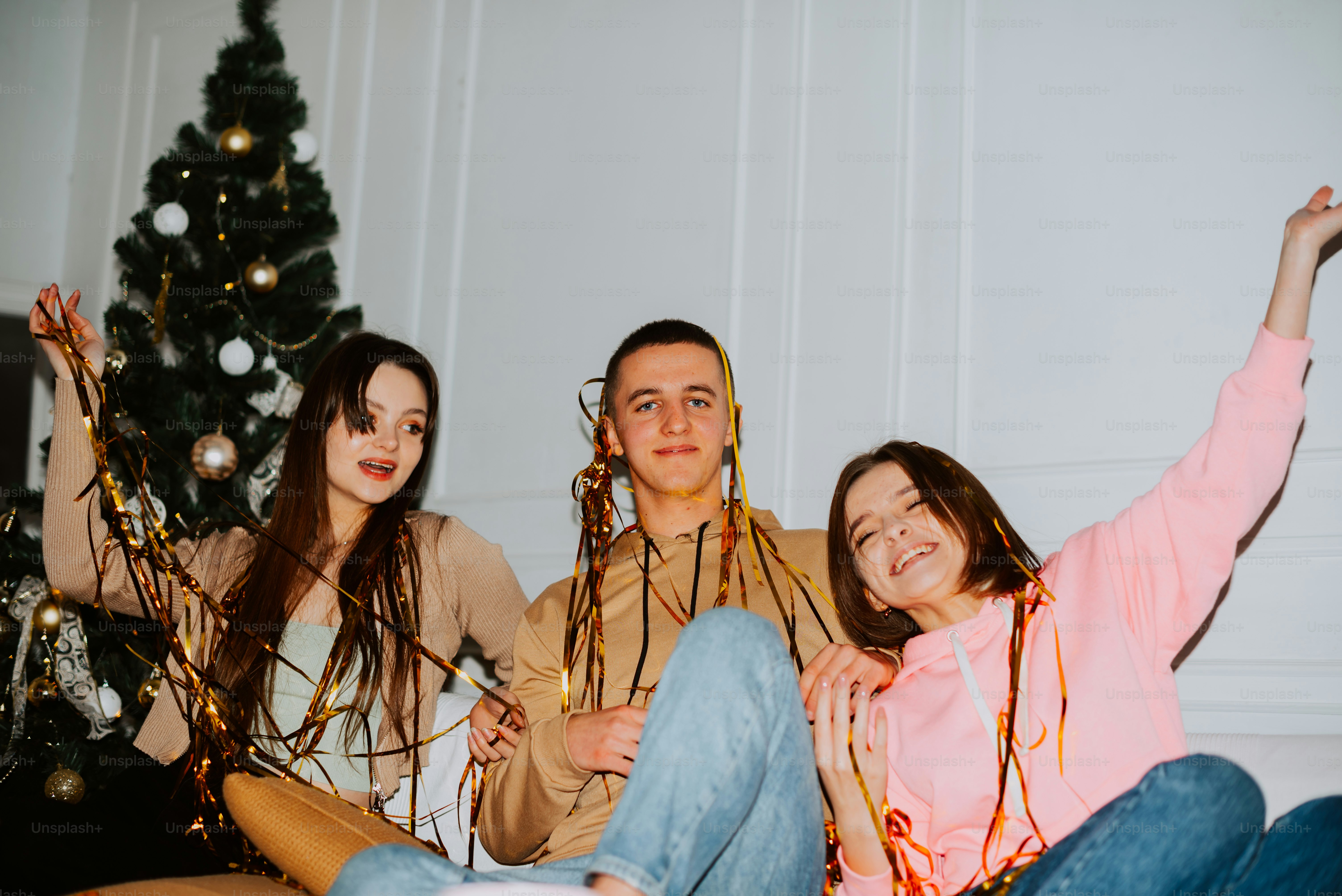 a group of young people sitting on top of a couch