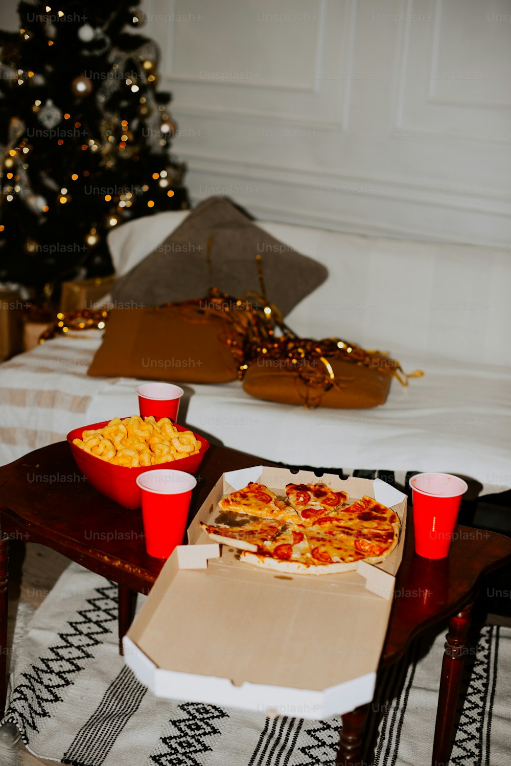 a box of pizza and cups on a table