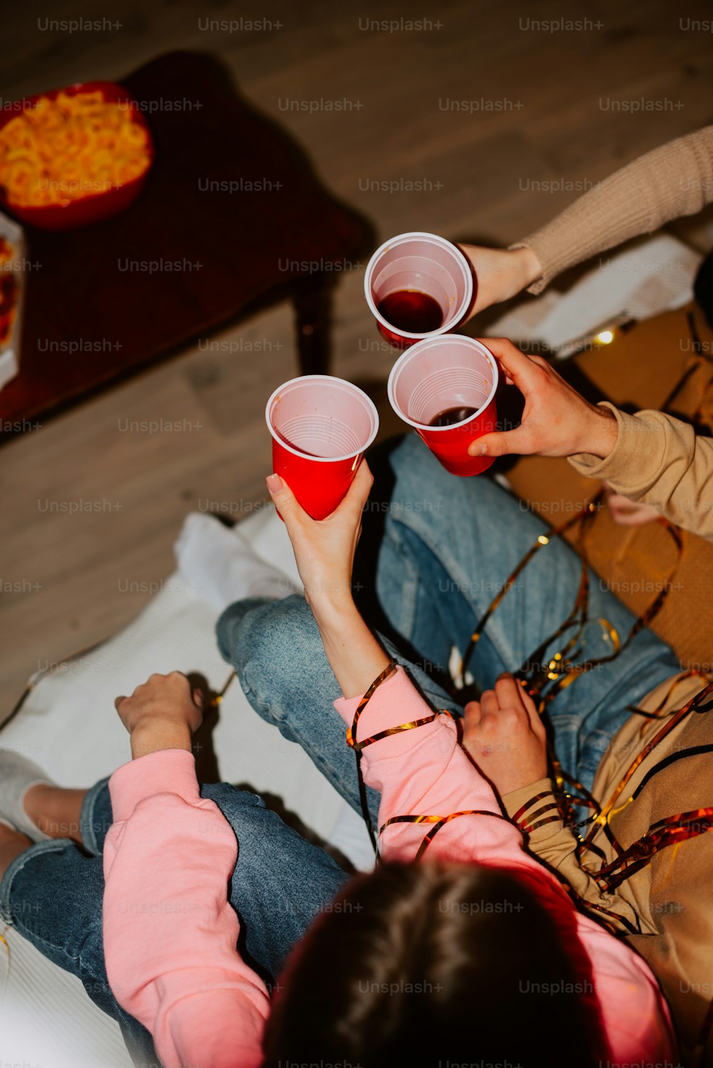 a couple of people sitting on top of a bed