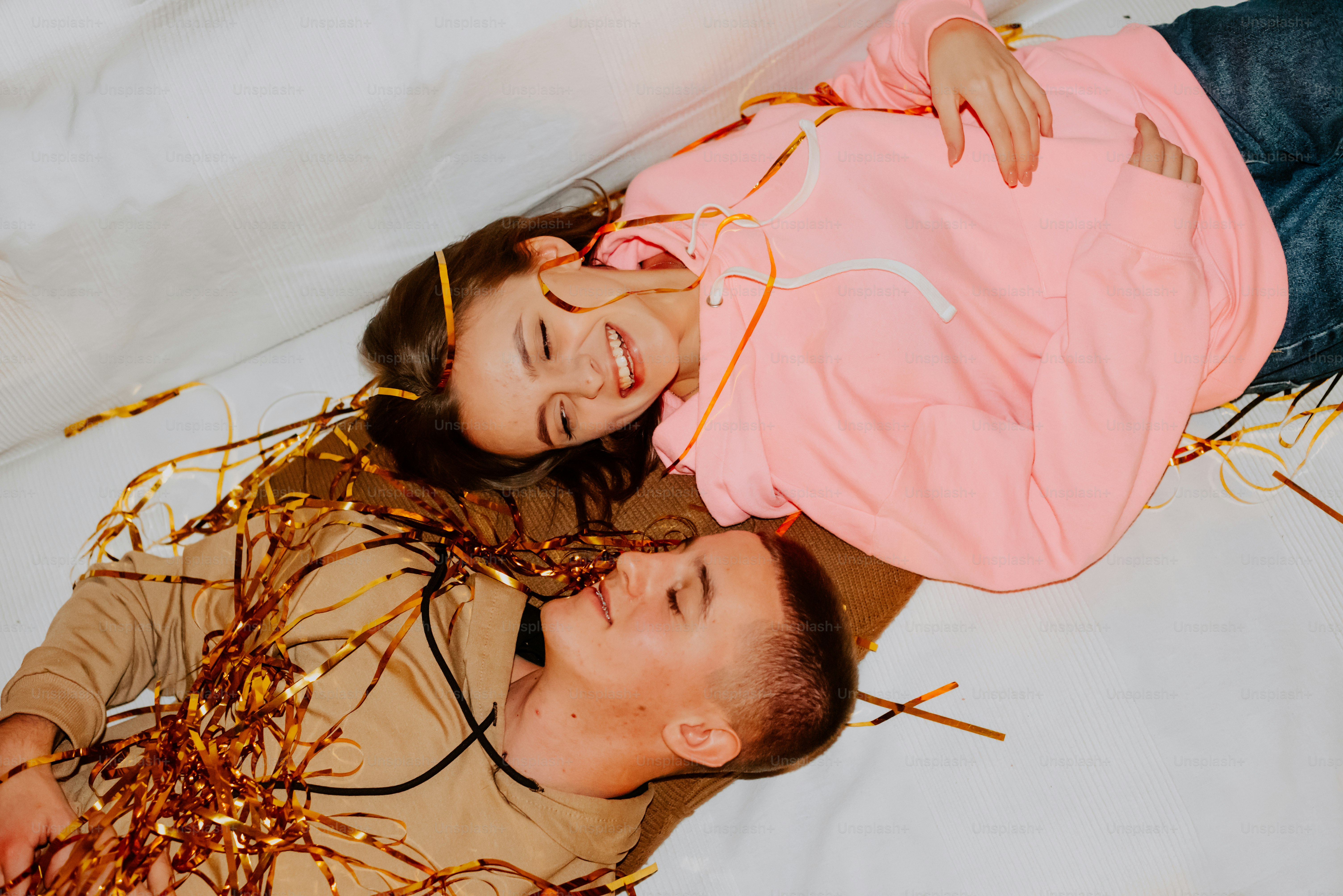 a man and a woman laying on a bed together