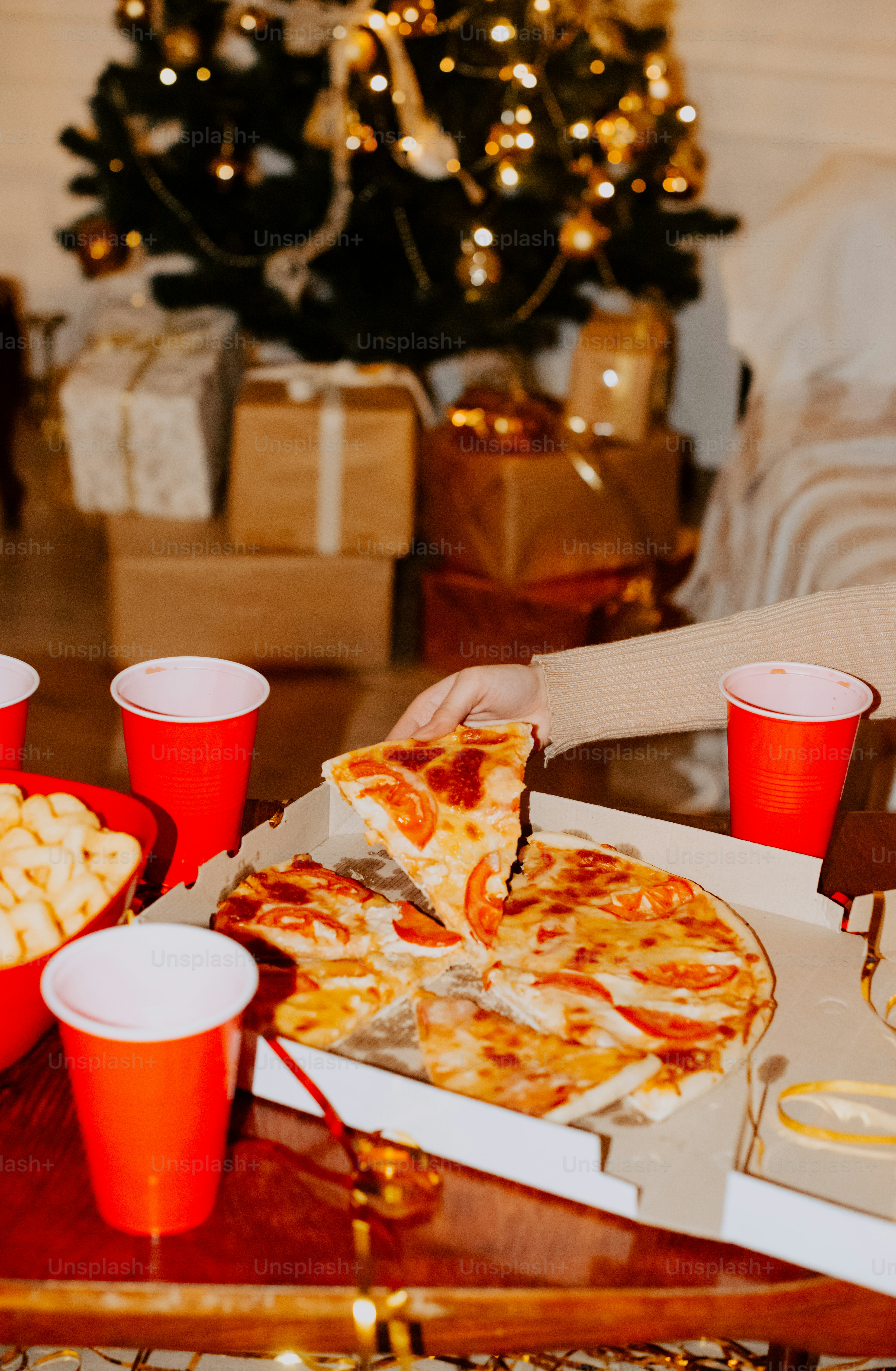 a table topped with pizza and cups filled with drinks