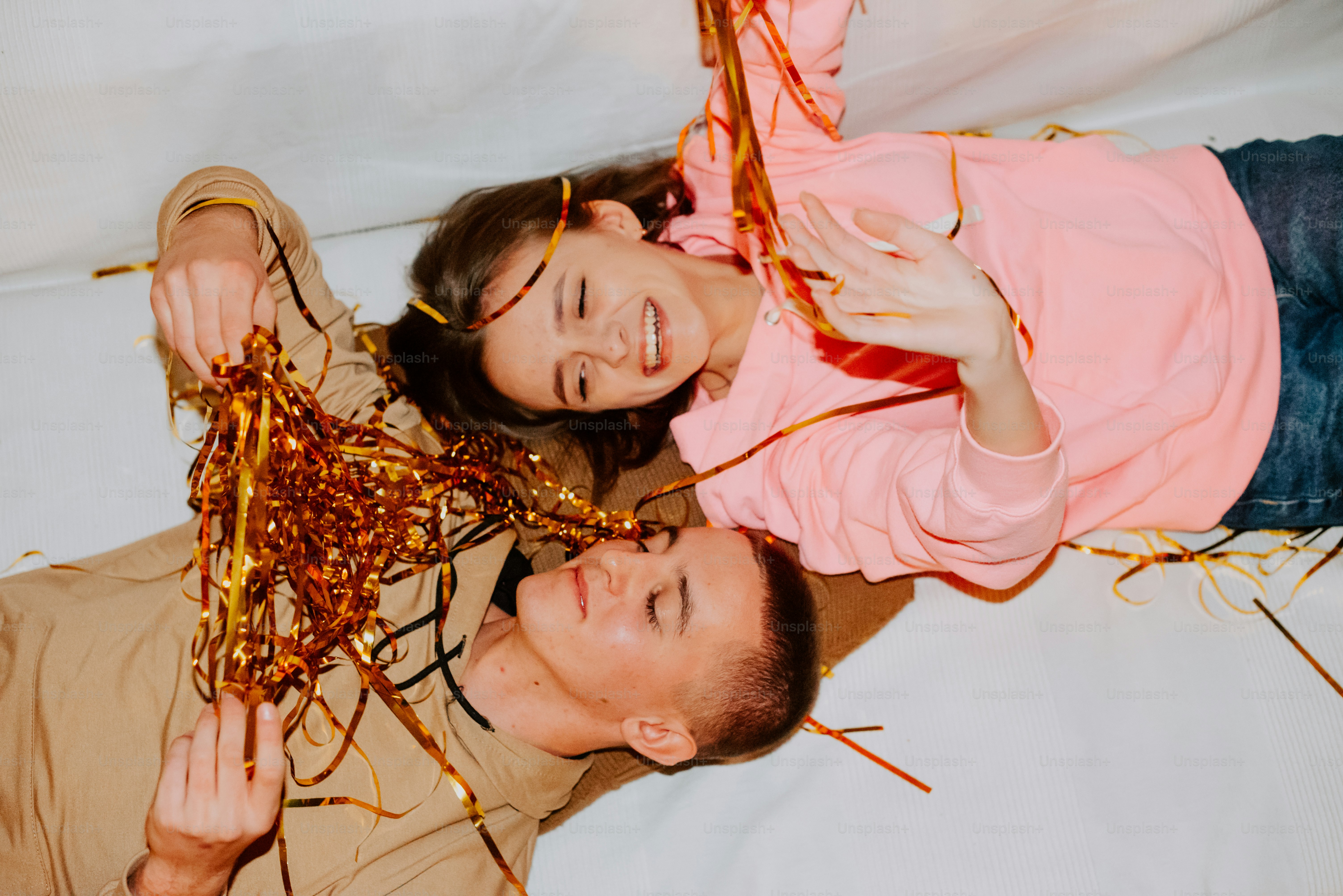 a man and a woman laying on top of a bed