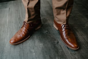 a close up of a person wearing brown shoes