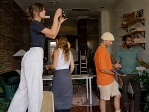 a group of people standing around a living room