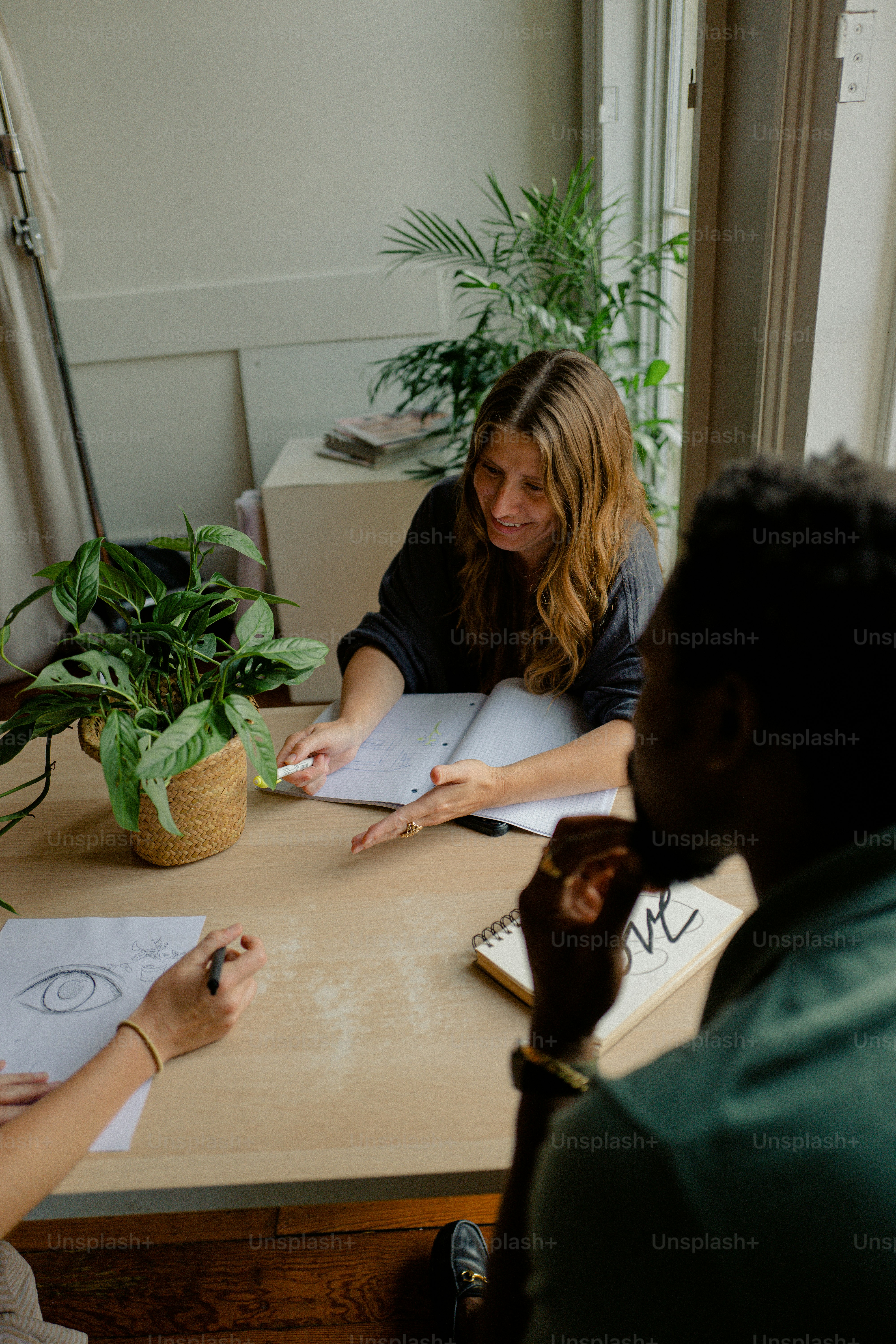 two people sitting at a table with papers