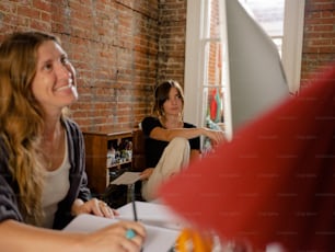 two women sitting at a table in a room