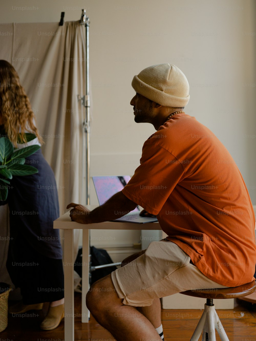 a man sitting on a chair in front of a woman