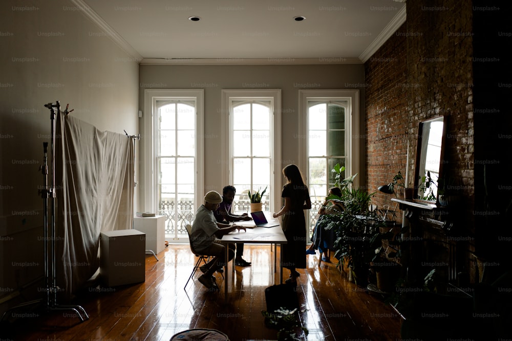 a couple of people sitting at a table in a room