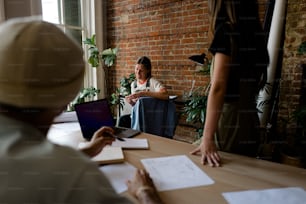 a person sitting at a table with a laptop