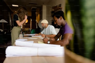 a group of people sitting around a wooden table