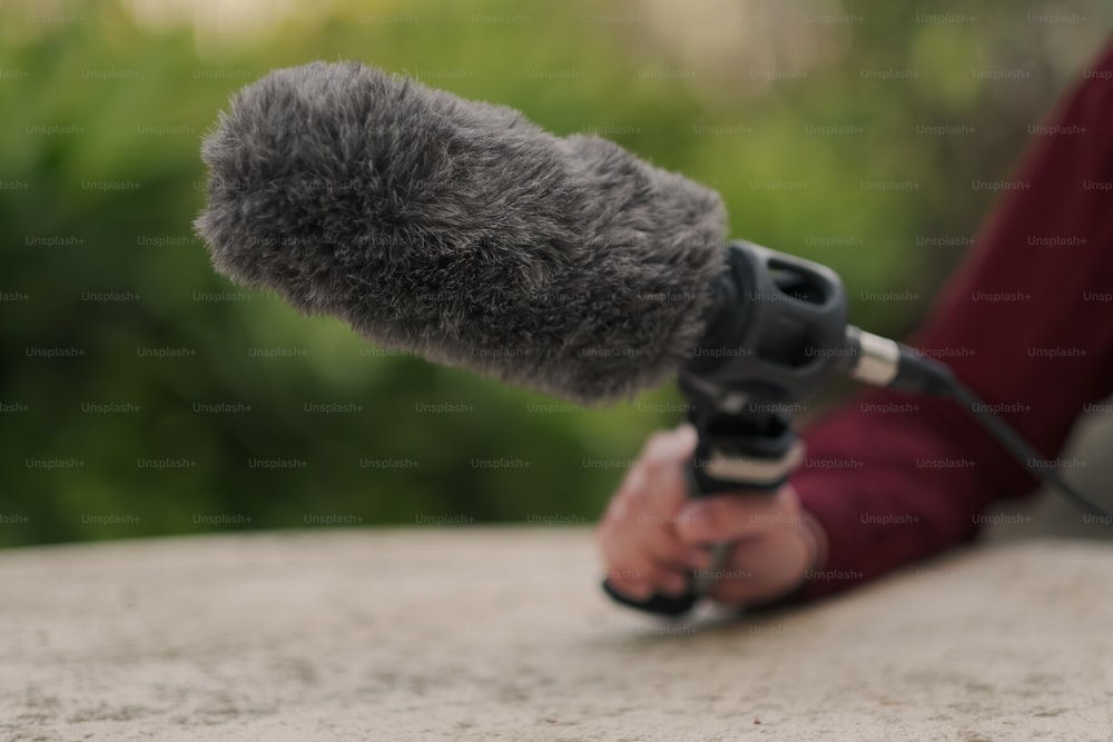 a person holding a microphone in their hand