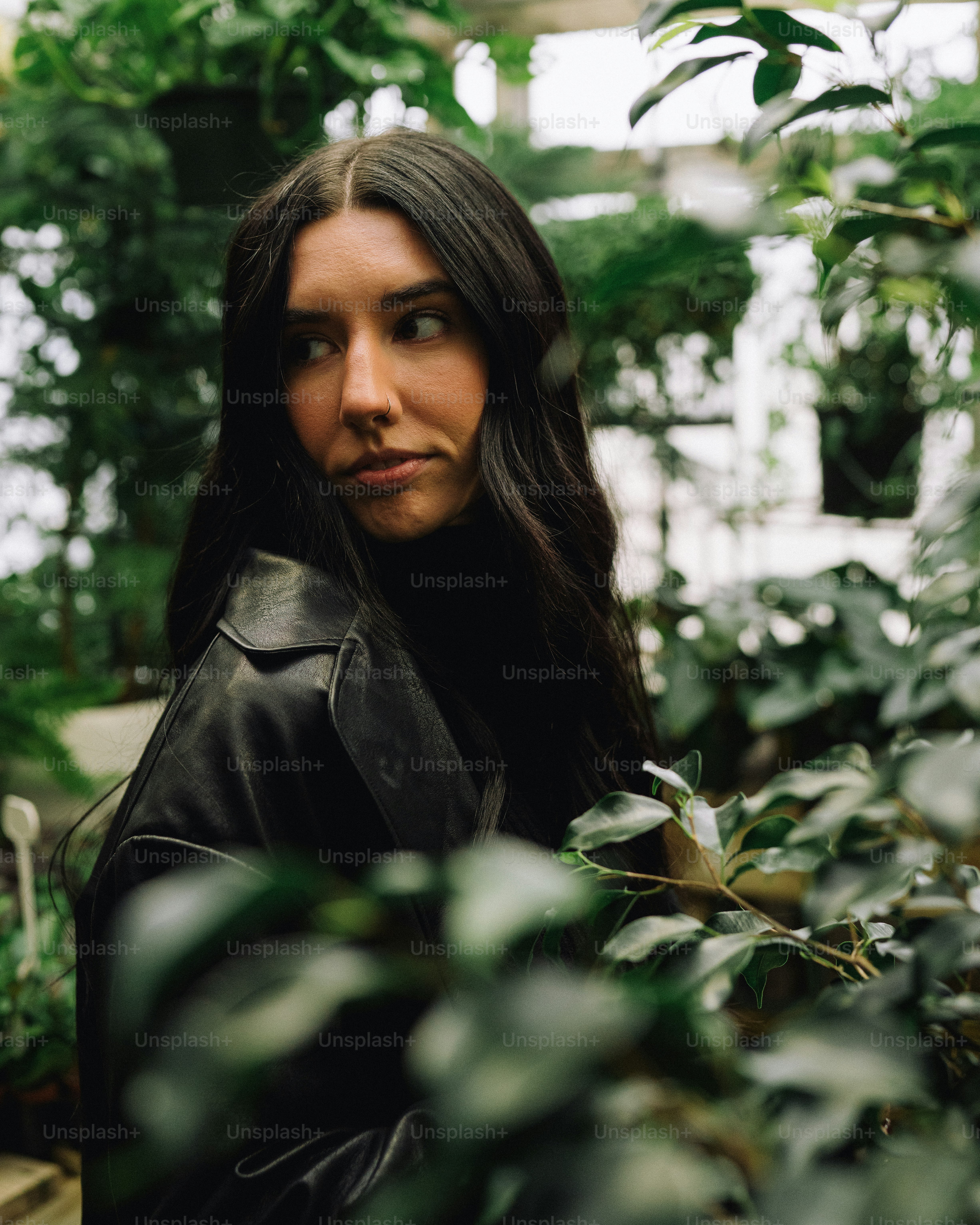 A woman standing in a greenhouse looking at the camera photo – Foliage ...