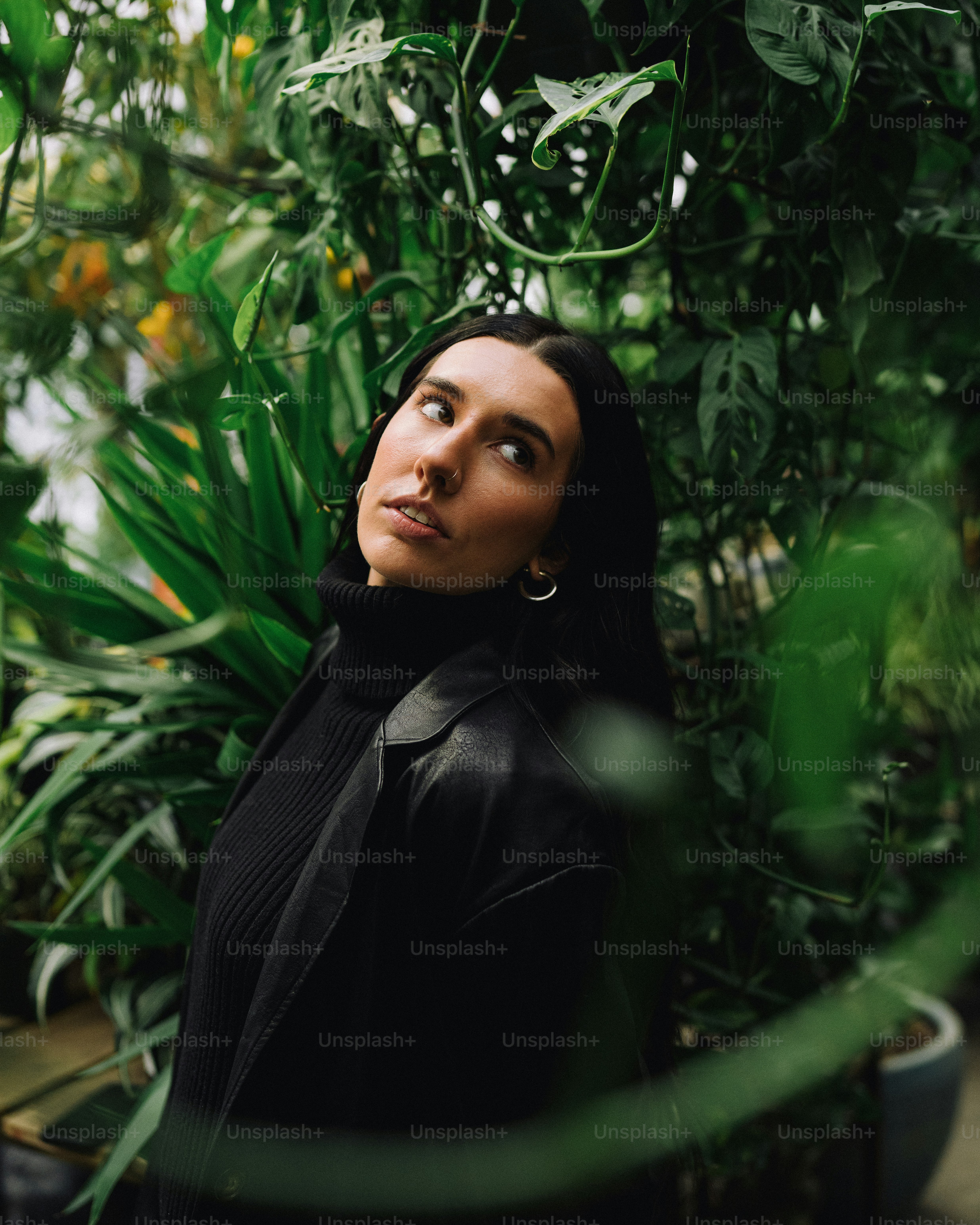 a woman standing in front of some plants