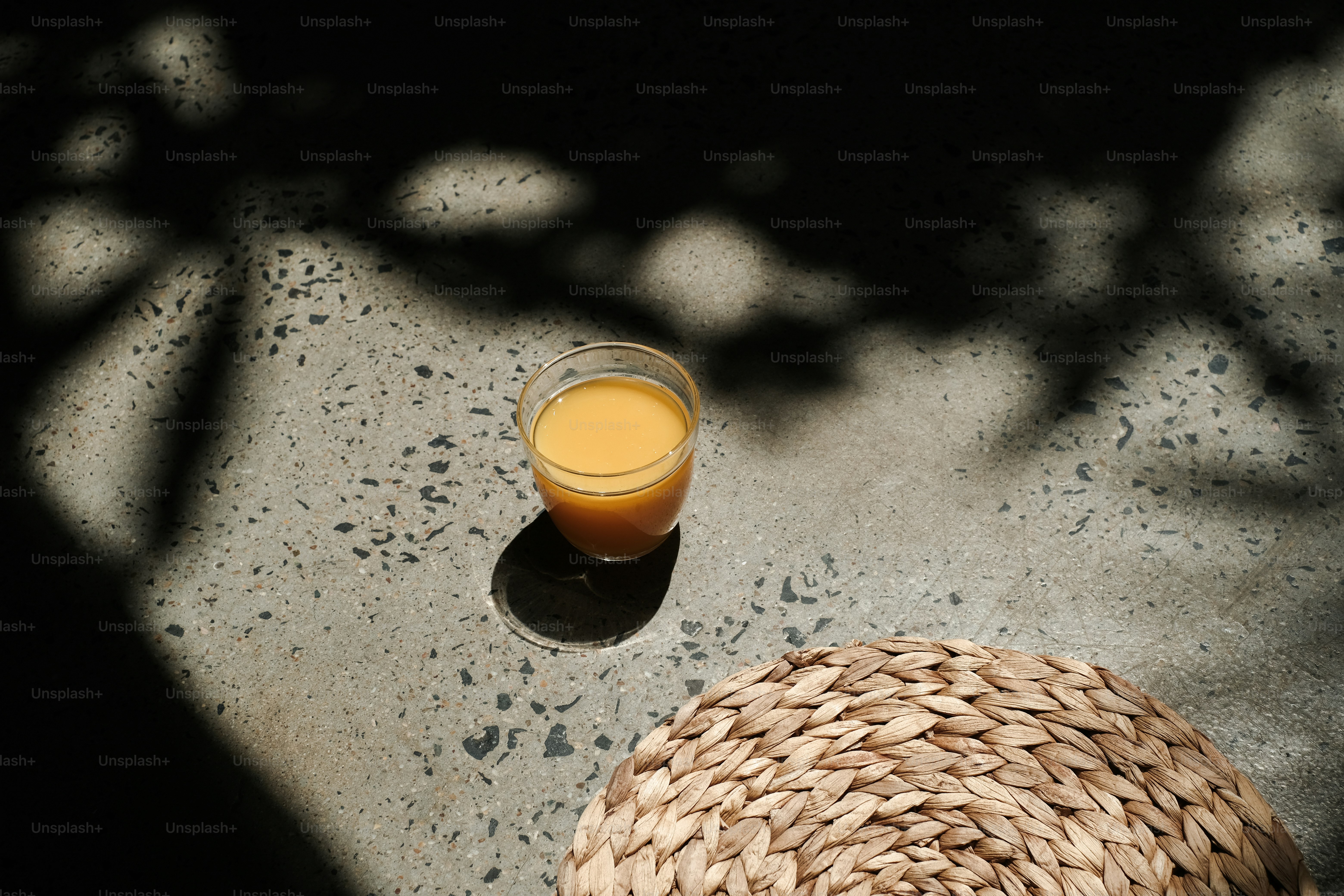 a straw hat and a glass of orange juice