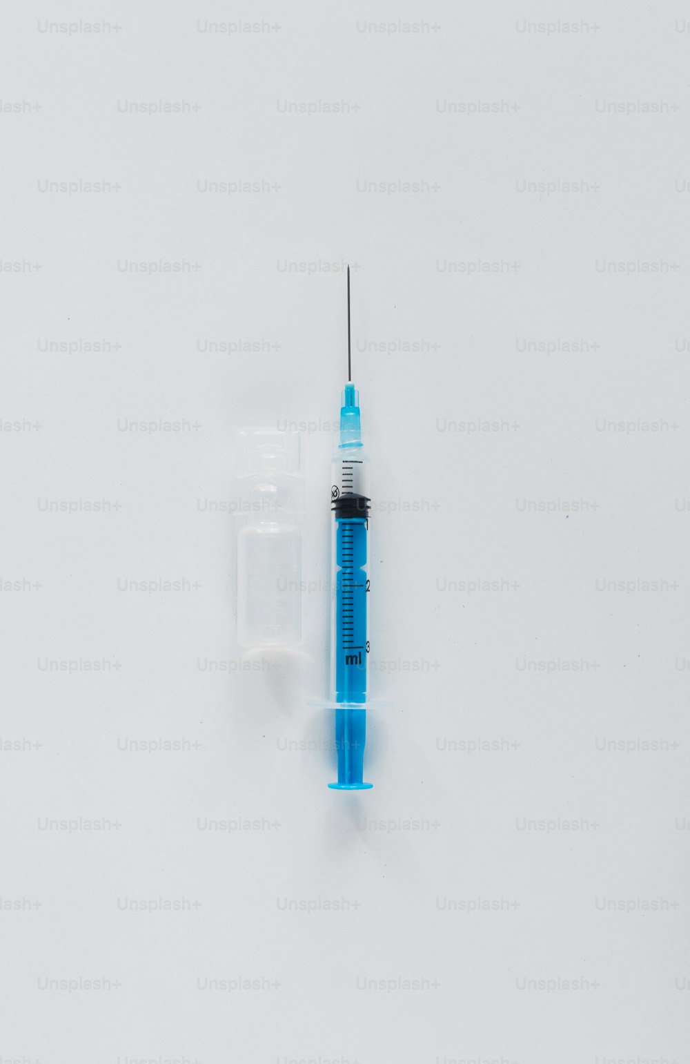 a small blue tube with a needle sticking out of it