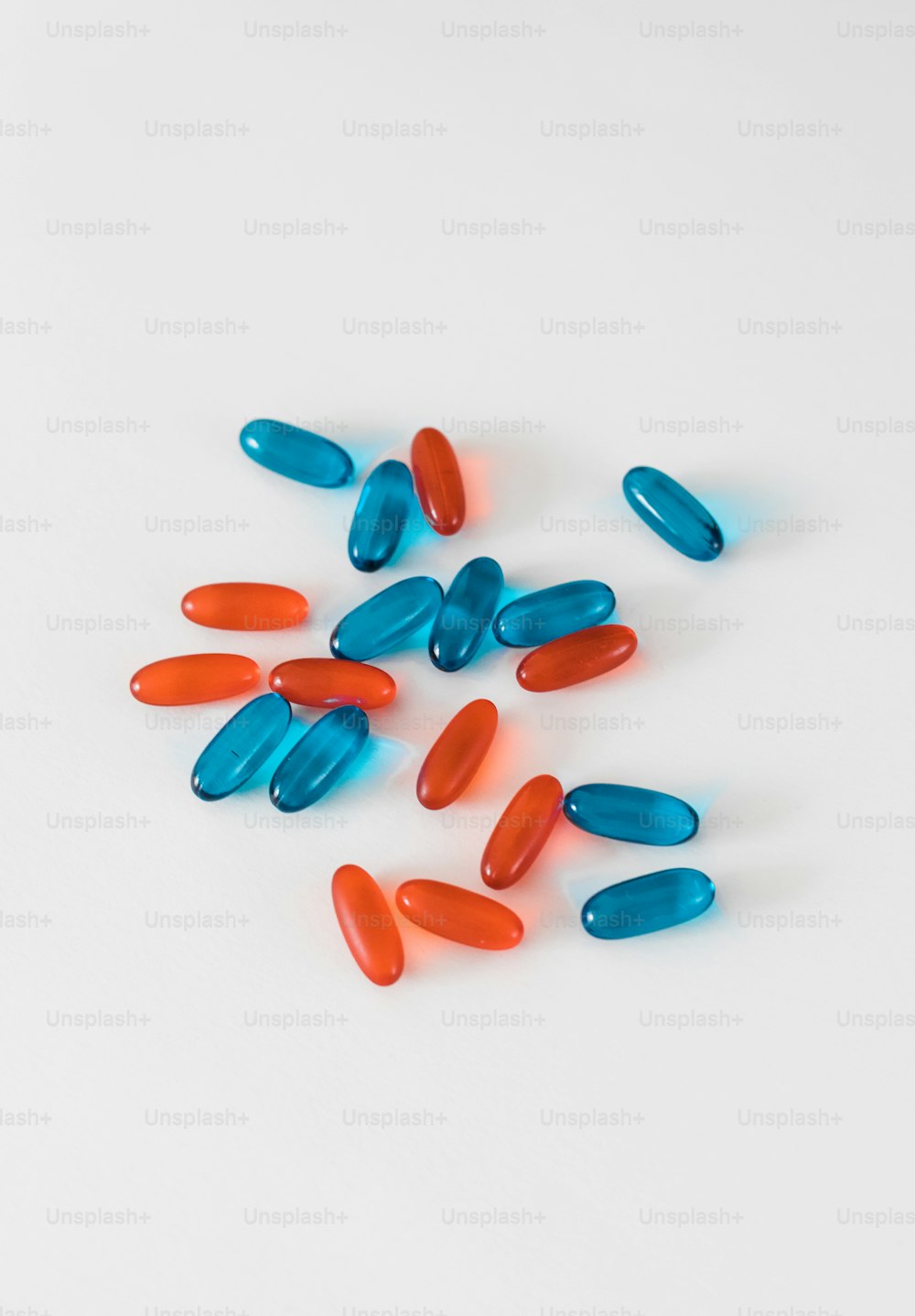 a bunch of pills sitting on top of a white table