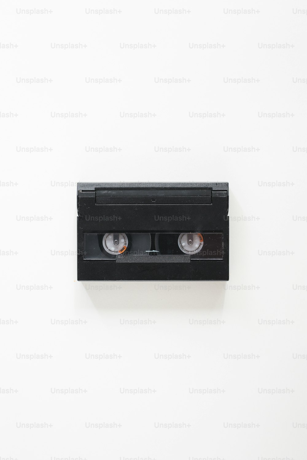 a pair of black tape recorders on a white wall