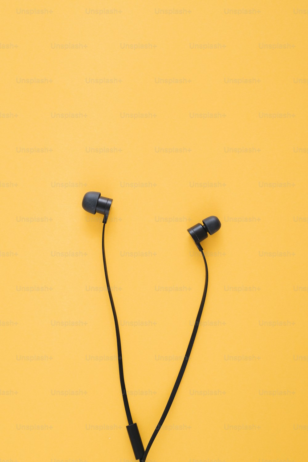 a pair of headphones on a yellow background