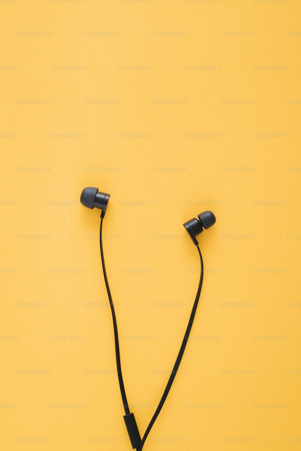 a pair of headphones on a yellow background