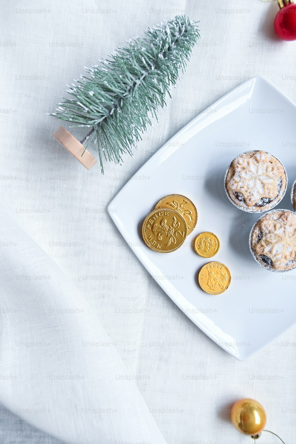 a white plate topped with cookies next to a christmas tree