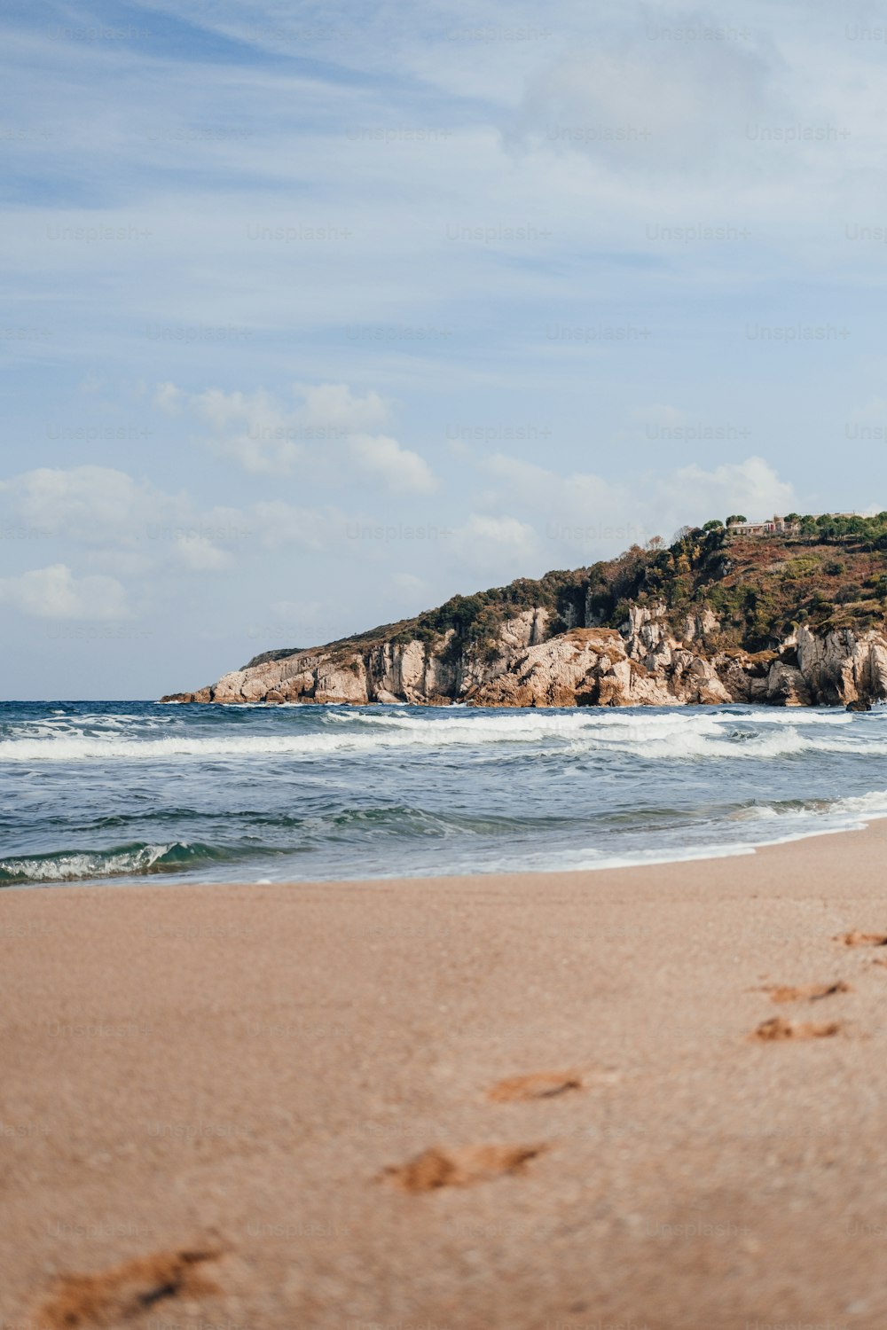 a person walking on a beach next to the ocean