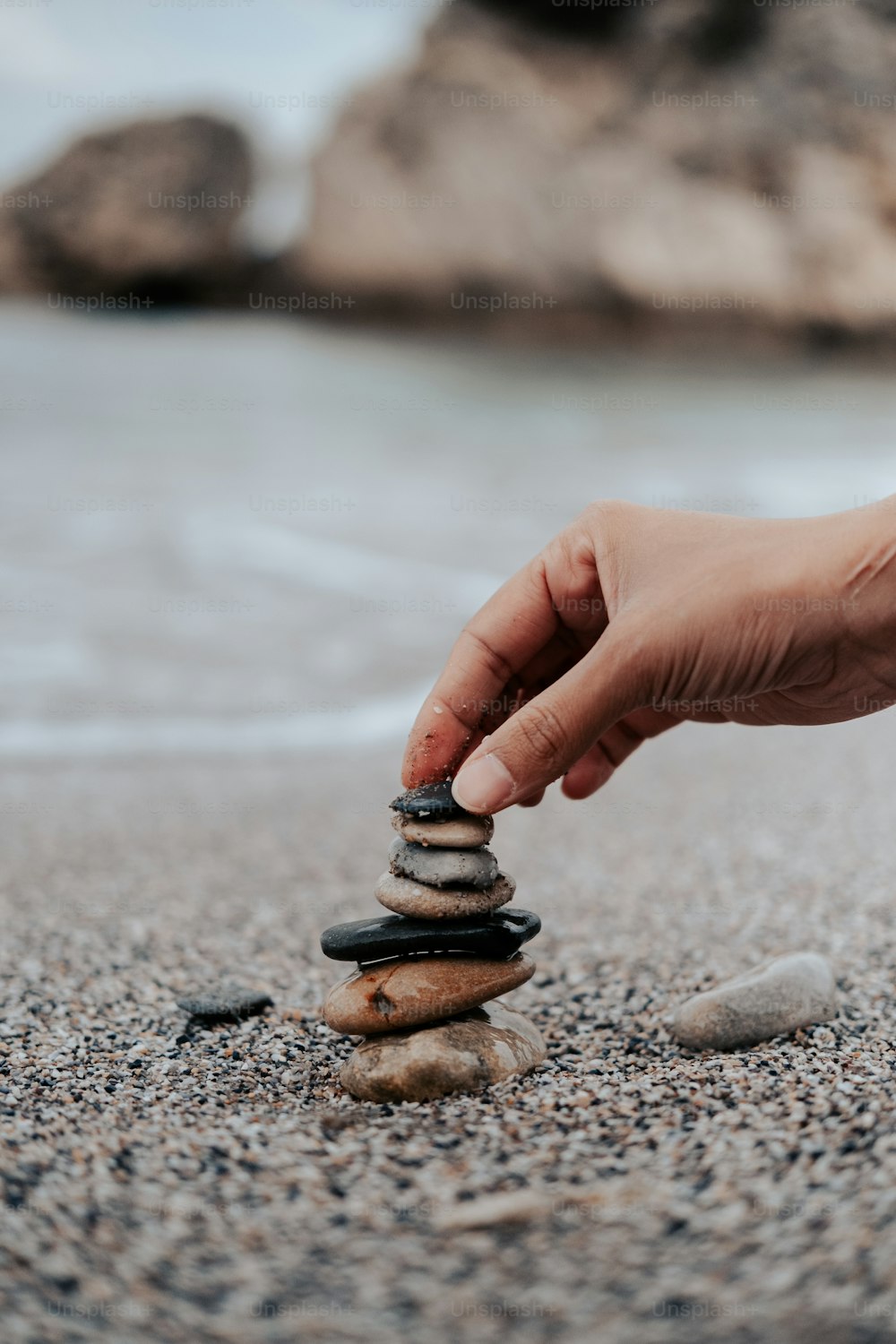 a person stacking rocks on top of each other