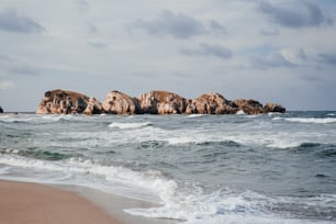 a rocky outcropping in the middle of the ocean