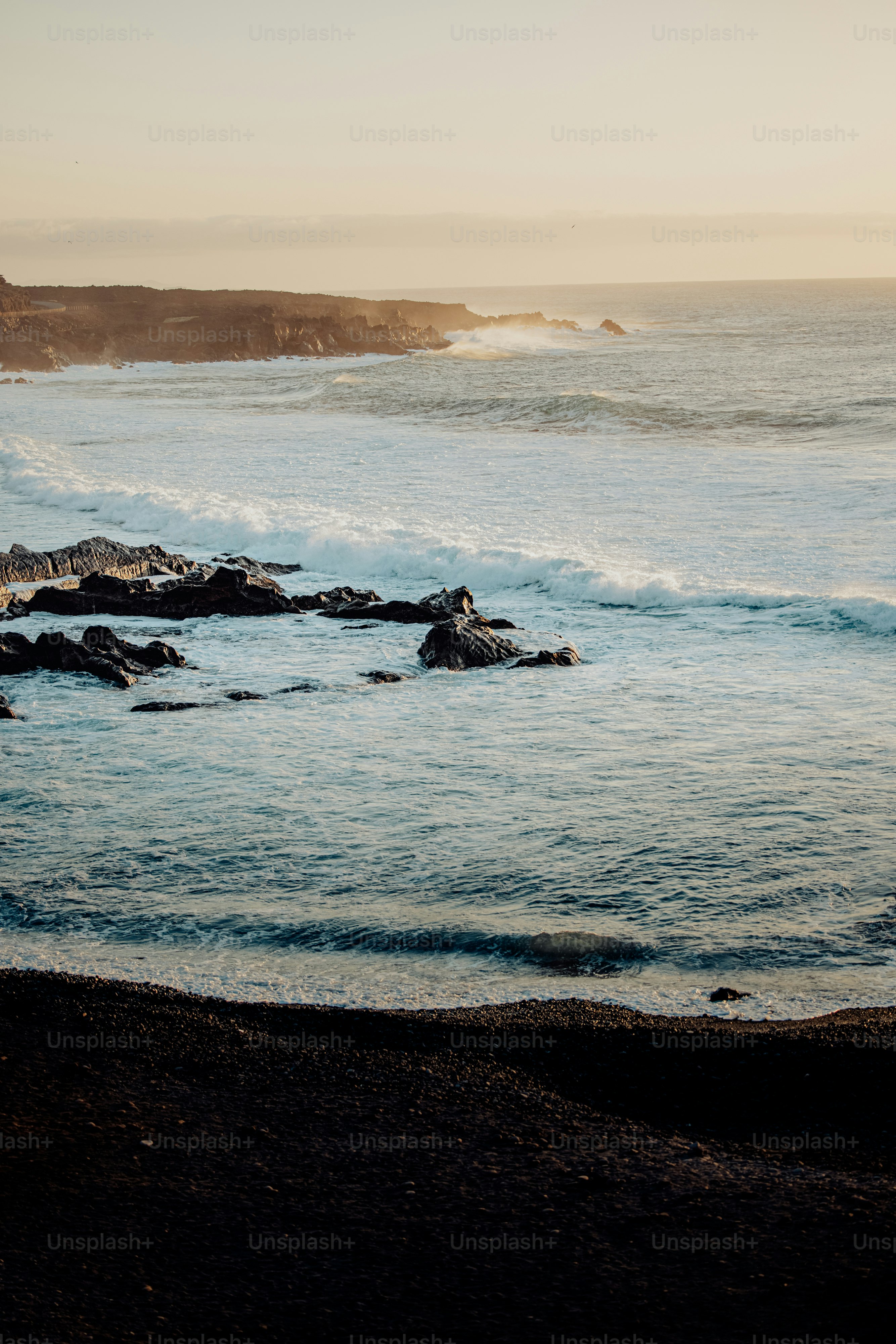 a body of water near a rocky shore