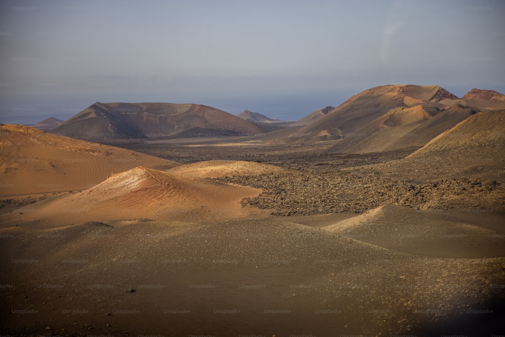 a desert landscape with mountains in the distance