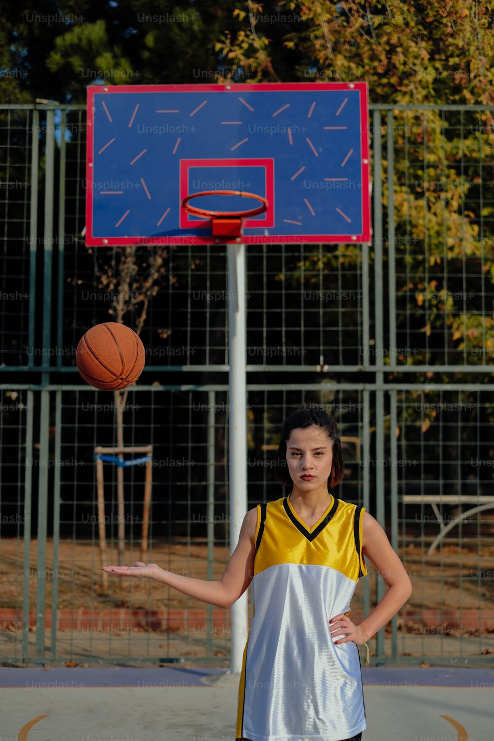 a young girl is playing basketball on a court